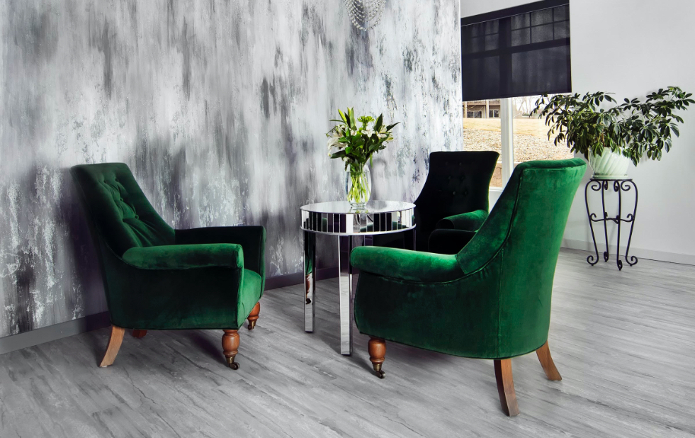 Green lounge chairs with floral arrangement at Eleven Salon